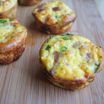 Meal Prep Egg Muffins on a cutting board with spinach