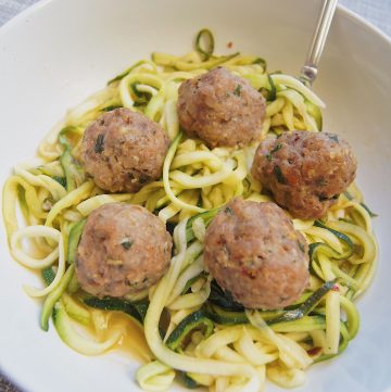 Trukey-Meatballs-and-zoodles-in-a-bowl-with-a-fork-on-a-gray-background