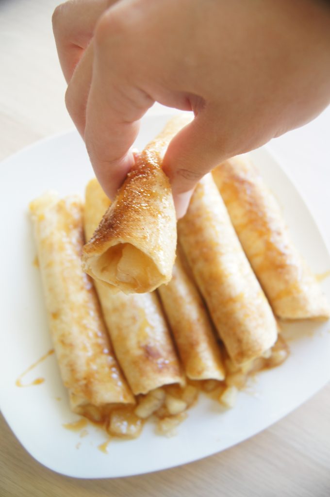 Caramel-Apple-Roll-ups-with-hand-holding-one